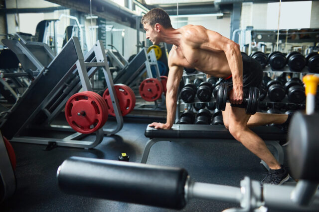 Handsome man building muscles in 603053